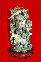 Spanish jade sculpture of flowers on wooden stand