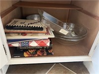 Cookbooks bowls casserole dish contents of cabinet