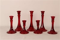 COLLECTION OF RED GLASS CANDLESTICKS