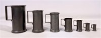 7 Pewter measures, graduated, 1" base, 1.75" T