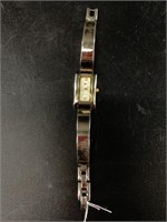 Ladies wrist watch with heavy metal band in workin