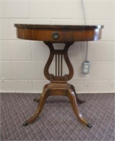 Drum table with one drawer on Lyre base, claw