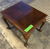 End table with curved legs, art design marks to