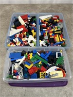 Assortment of legos and 3 plastic storage bins