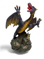 Purple dragon on rock spire figure