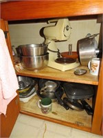 Everything in bottom cupboard left side of sink