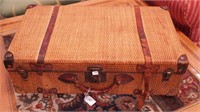 Vintage wicker suitcase with leather strapping