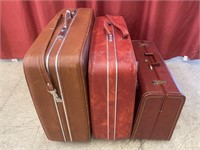 3 mismatched suitcases