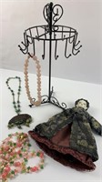 Jewelry stand, necklaces, ceramic doll