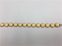 14 karat gold shell bracelet;
