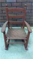 Small red woven wooden chair