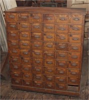 Oak card catalog with six drawers across and nine