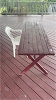 Small wooden picnic table and plastic chair