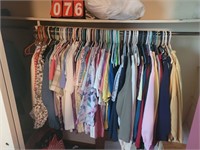 closet in master bedroom full of womens clothes