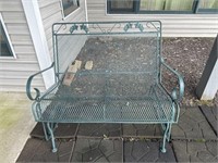 Green iron outdoor gliding bench