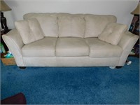 CREAM COLORED SOFA; ARMS STAINED(AS SEEN IN