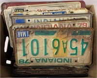 Box of various old license plates