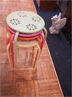 Group of four stacking metal stools with star