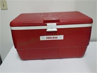 large red Igloo snap-top travel cooler