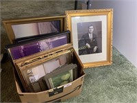 Box full of picture frames and small prints