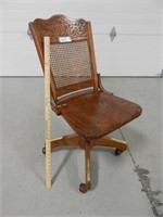 Antique office chair on wheels, back-rest is loose