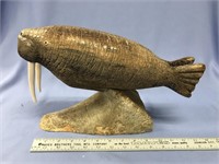 9" x 14 1/2" fossilized bone carving of a walrus w