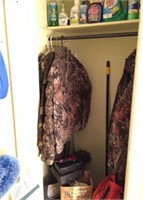 Contents of Utility Closet: camo jackets, brooms,