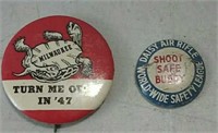 Two advertising pins
