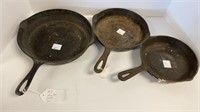 (3) cast iron skillets (1 has a 6)
