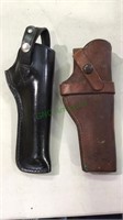 Two leather gun holsters, one JH Heiser maker