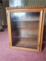 Wooden cabinet with glass shelving.