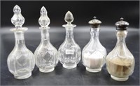Five various cut glass condiment bottles