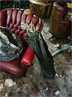 set of vintage golf clubs with older leather