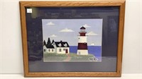 Lighthouse print, dark blue mat in oak frame,