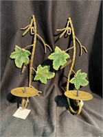 Pair of metal candleholders with ceramic leaves.