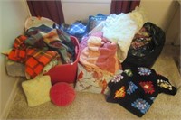 Large group of linens including crochet blankets,