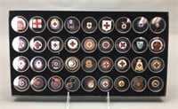 36 medals, buttons, and lapel pins.