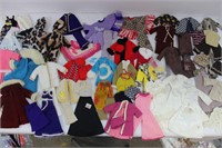 Assortment of vintage hand-made Barbie ensembles.