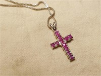 STERLING SILVER RUBY CROSS PENDANT ON CHIN