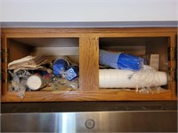 Contents of kitchen cupboard above microwave
