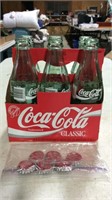 6 pack Coca Cola bottles and lids