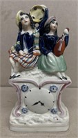 Porcelain figurine of girls playing instruments
