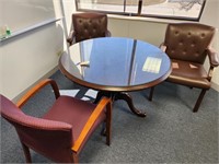 Round conference table and 3 office chairs.