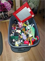 Tub of assortment of toys with etch a sketch