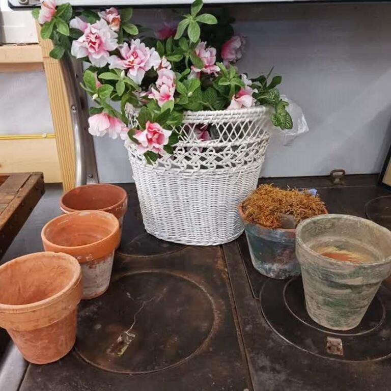 Clay pots, white wicker basket with flowers