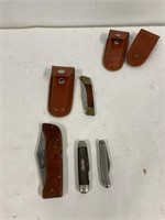 Four assorted pocket knives.
