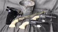 3 cap guns and gun holster in bucket