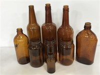 Collection of empty brown glass bottles and jars