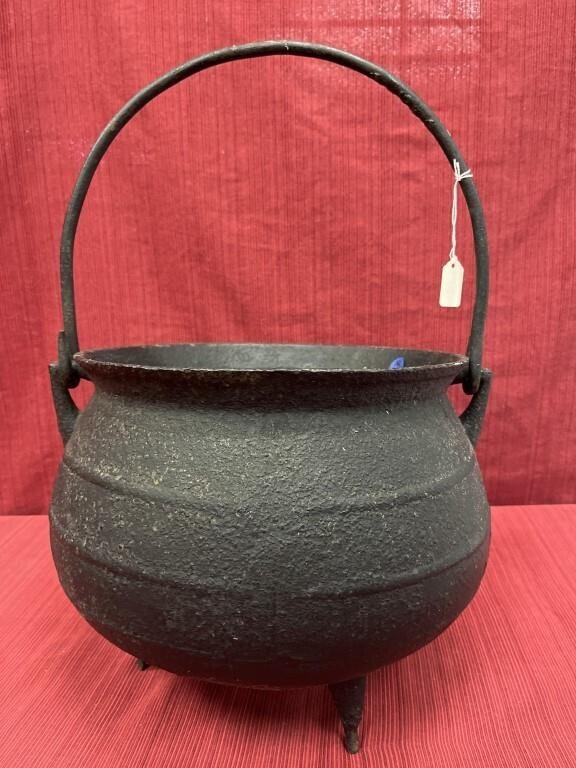 Cast iron footed cauldron with bell handle