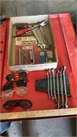 Various hand tools, sunglasses, steering wheel